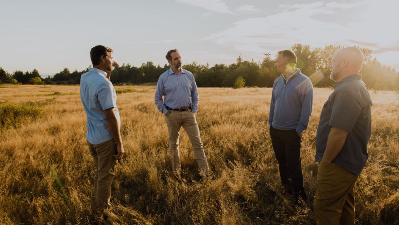 Cultivate About Header Image - 4 Partners Standing in a Field